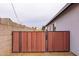 Backyard features a well-maintained privacy fence with gate and lush gravel landscaping at 813 E Glendale Ave, Phoenix, AZ 85020