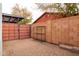 Private backyard featuring a brick-paved patio area, walled for seclusion, with a metal shelf for storage at 813 E Glendale Ave, Phoenix, AZ 85020