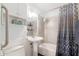 Cozy bathroom featuring a pedestal sink and a bathtub shower combination at 813 E Glendale Ave, Phoenix, AZ 85020