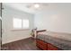 Bedroom with a ceiling fan, plantation shutters and drawers under the bed at 813 E Glendale Ave, Phoenix, AZ 85020