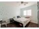 Bedroom with desk, queen bed, ceiling fan and plantation shutters allowing natural light at 813 E Glendale Ave, Phoenix, AZ 85020