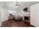 This inviting bedroom features a fireplace, ceiling fan and wood-look flooring at 813 E Glendale Ave, Phoenix, AZ 85020