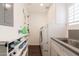 Organized laundry room featuring modern washer and dryer, sink, counter space, and ample shelving at 813 E Glendale Ave, Phoenix, AZ 85020