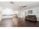 Open-concept living room showcasing hardwood floors and seamless access to the kitchen at 813 E Glendale Ave, Phoenix, AZ 85020