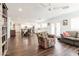 This well lit living room has a ceiling fan and flows into the dining and kitchen areas at 813 E Glendale Ave, Phoenix, AZ 85020