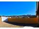 View of a backyard with a block wall, gravel, and mountain views in the distance at 8213 S 25Th St, Phoenix, AZ 85042