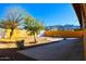 Landscaped backyard with a patio, sitting area, and mountain views at 8213 S 25Th St, Phoenix, AZ 85042