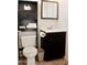 Clean bathroom with dark vanity, toilet and shelving at 8213 S 25Th St, Phoenix, AZ 85042