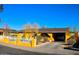 Eye-level view of a yellow house with a front yard, driveway, and a fence at 8213 S 25Th St, Phoenix, AZ 85042