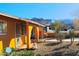 House exterior showcasing a covered entryway, desert landscaping, and mountain backdrop at 8213 S 25Th St, Phoenix, AZ 85042