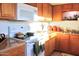 View of a kitchen with light wood cabinets, white appliances, and granite countertops at 8213 S 25Th St, Phoenix, AZ 85042