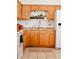 Kitchen with light wood cabinets, a white refrigerator and a double sink at 8213 S 25Th St, Phoenix, AZ 85042