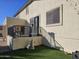 Elevated patio with built-in heater and metal railings overlooks grassy backyard at 8605 W Carole Ln, Glendale, AZ 85305