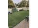 Lush backyard featuring artificial turf, seating area, and serene atmosphere at 8605 W Carole Ln, Glendale, AZ 85305