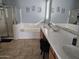 Elegant bathroom with double sinks, a soaking tub, and a shower at 8605 W Carole Ln, Glendale, AZ 85305