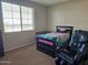 Bedroom with a twin bed and a massage chair at 8605 W Carole Ln, Glendale, AZ 85305