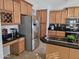 Kitchen with stainless steel refrigerator and granite countertops at 8605 W Carole Ln, Glendale, AZ 85305