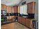 Kitchen features dark granite countertops and wood cabinets at 8605 W Carole Ln, Glendale, AZ 85305