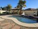 Entertain in style by the kidney-shaped pool with outdoor kitchen at 8605 W Carole Ln, Glendale, AZ 85305