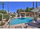 Community pool with lounge chairs and umbrellas at 8849 S 48Th St # 2, Phoenix, AZ 85044