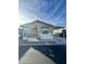 Tan and white single-wide manufactured home with covered porch and carport at 9333 E University Dr # 51, Mesa, AZ 85207