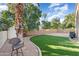 Landscaped backyard with artificial turf and patio at 9377 E Corrine Dr, Scottsdale, AZ 85260