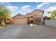 Two-story house with tan exterior, double garage, and landscaped front yard at 9377 E Corrine Dr, Scottsdale, AZ 85260