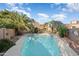 Inviting kidney-shaped pool surrounded by a large patio and lush landscaping at 9377 E Corrine Dr, Scottsdale, AZ 85260