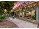 Backyard featuring large windows offering views of the home's interior, lush landscaping, and natural light at 9734 N 105Th Dr, Sun City, AZ 85351