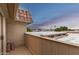 Upper balcony with view of neighborhood palm trees and tile roofs at 9734 N 105Th Dr, Sun City, AZ 85351