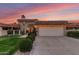 Inviting home showcasing a two-car garage, mature landscaping and a charming tile roof at 9734 N 105Th Dr, Sun City, AZ 85351