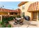 Small patio with table and chairs, grill, and lush greenery at 9734 N 105Th Dr, Sun City, AZ 85351