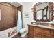 Stylish bathroom with a unique mirror, glass bowl sink, and modern fixtures at 10878 E Sundance Trl, Scottsdale, AZ 85262