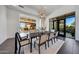 Modern dining room with open layout, stylish lighting, and access to an outdoor dining area at 10878 E Sundance Trl, Scottsdale, AZ 85262