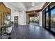 Spacious foyer with tile flooring, modern lighting fixture, and large glass entry door with views of the landscape at 10878 E Sundance Trl, Scottsdale, AZ 85262