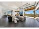 Open living room with fireplace, modern furnishings, sleek flooring, and seamless transition to the outdoor space at 10878 E Sundance Trl, Scottsdale, AZ 85262