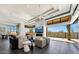 Bright living room with sleek fireplace, tile floors, neutral colors, and an expansive sliding glass door at 10878 E Sundance Trl, Scottsdale, AZ 85262