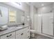 Bright bathroom with granite countertops, a glass shower, and modern fixtures at 12527 W Sierra Vista Ct, Glendale, AZ 85307