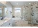 Beautiful bathroom showing a glass-enclosed shower, soaking tub, and double vanity at 12527 W Sierra Vista Ct, Glendale, AZ 85307