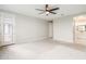 Spacious bedroom featuring a ceiling fan, ensuite bath and a sliding door to the balcony at 12527 W Sierra Vista Ct, Glendale, AZ 85307