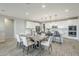 Well-lit dining area with modern table and barstool seating at kitchen island at 12527 W Sierra Vista Ct, Glendale, AZ 85307