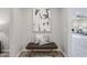 Cozy hallway nook with a wooden bench, decorative pillows, and stylish wall art at 12527 W Sierra Vista Ct, Glendale, AZ 85307