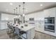 Spacious eat-in kitchen features a central island, stainless appliances, and white cabinets at 12527 W Sierra Vista Ct, Glendale, AZ 85307