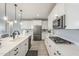 Well-lit kitchen has stainless steel appliances, an island with barstool seating, and stone countertops at 12527 W Sierra Vista Ct, Glendale, AZ 85307