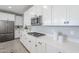 Bright kitchen featuring white cabinets, stainless steel appliances, stone countertops, and gas cooktop at 12527 W Sierra Vista Ct, Glendale, AZ 85307