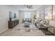 Comfortable living room with modern decor, neutral colors, and wood-look tile flooring at 12527 W Sierra Vista Ct, Glendale, AZ 85307