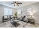 Well-lit living room with gray furniture, decorative artwork, and modern furnishings at 12527 W Sierra Vista Ct, Glendale, AZ 85307