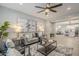 Inviting living room featuring a comfortable sofa, stylish decor, and a ceiling fan at 12527 W Sierra Vista Ct, Glendale, AZ 85307