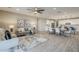 Open concept living and dining area flows into a modern white kitchen with stainless steel appliances at 12527 W Sierra Vista Ct, Glendale, AZ 85307