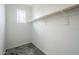 Bright walk-in closet featuring carpeted floors, a high window, and a wooden clothing rod at 12527 W Sierra Vista Ct, Glendale, AZ 85307